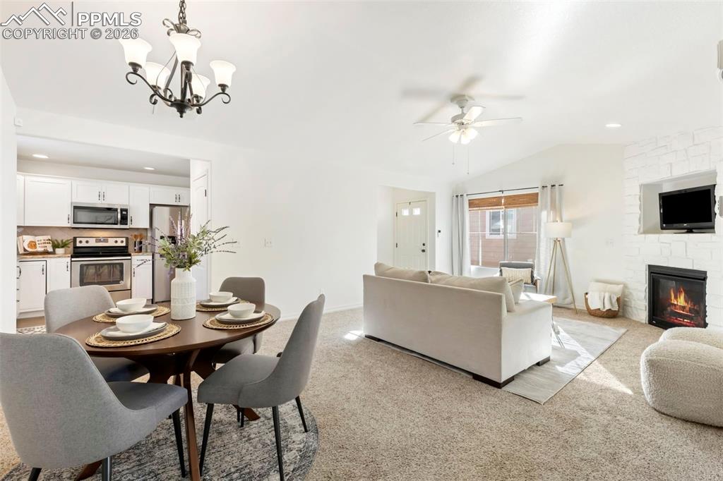 6528 Watusi Road Peyton, CO 80831 - Photo 7 of 27 a view of a dining room with furniture a chandelier and wooden floor