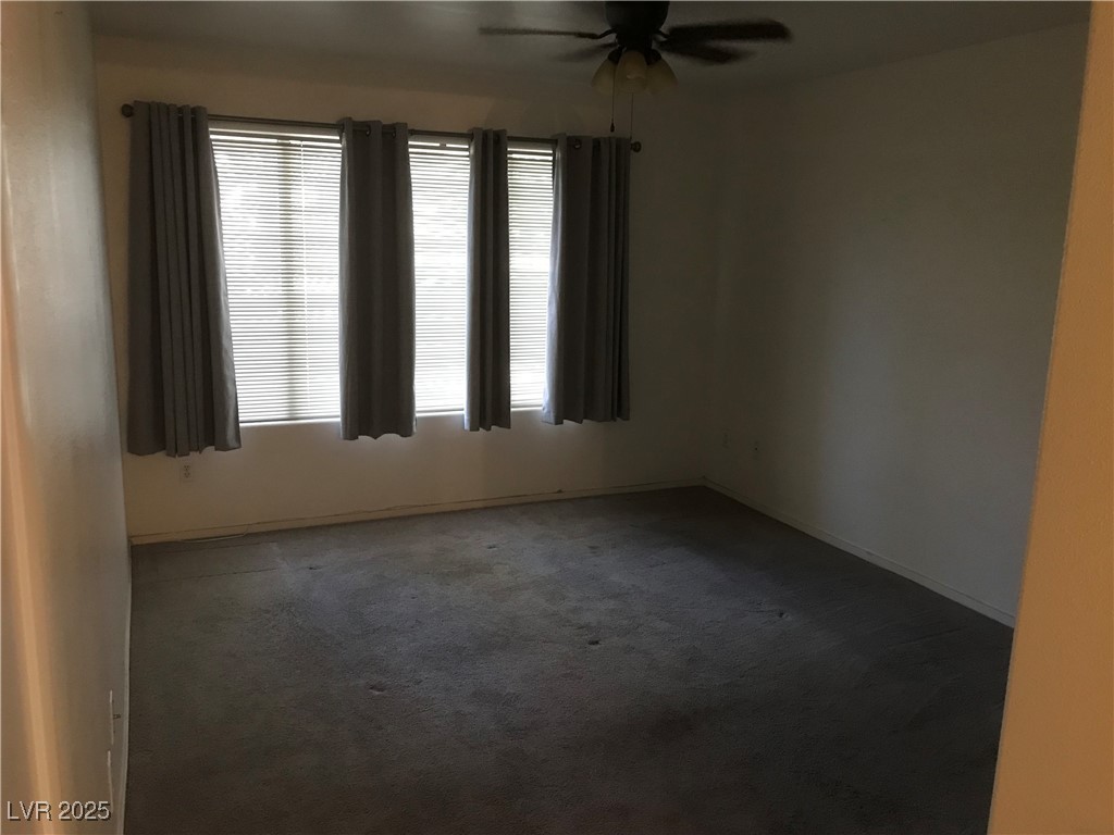 3425 East Russell Road, Unit 170 Las Vegas, NV 89120 - Photo 13 of 13 Unfurnished room with dark colored carpet and ceiling fan