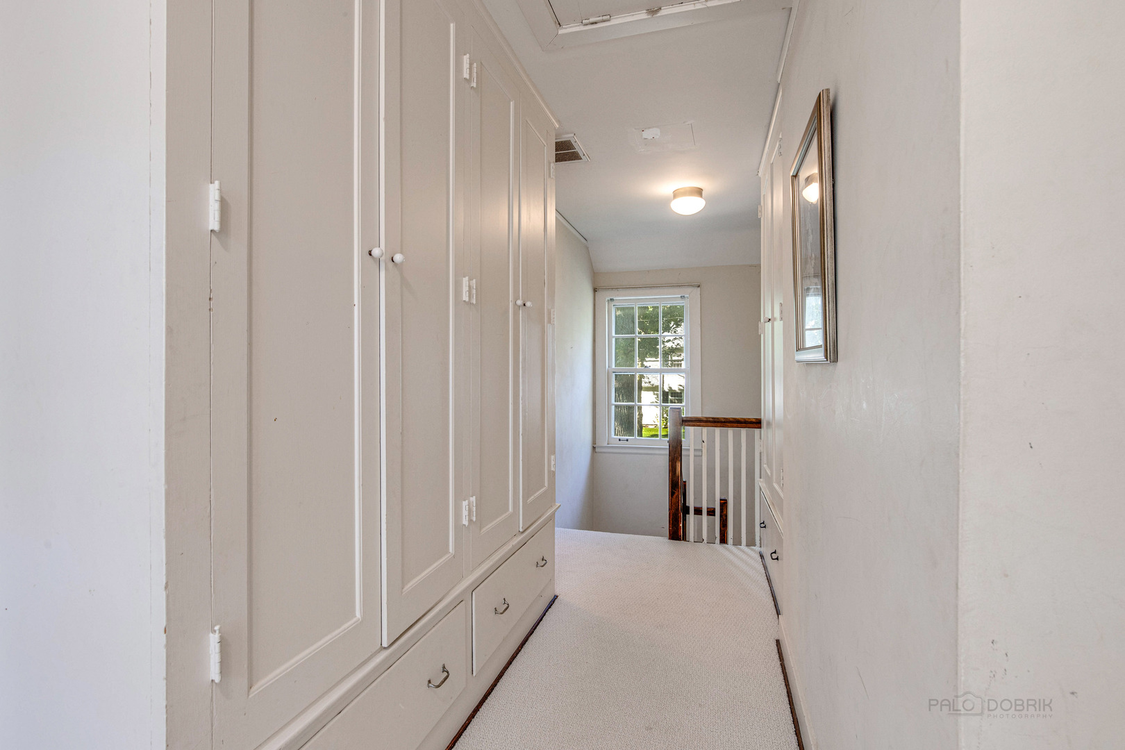 620 Spruce Street Winnetka, IL 60093 - Photo 21 of 26 a view of a hallway with wooden floor and cabinet