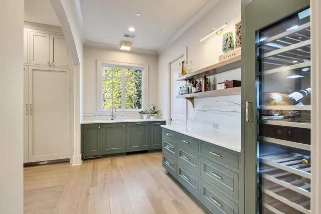 a kitchen with a stove a sink and a window
