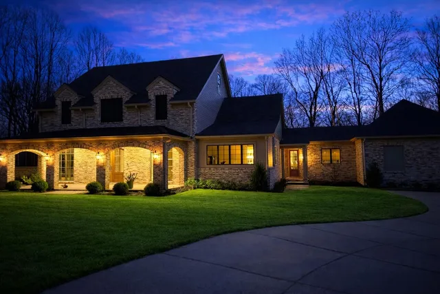 a front view of house with yard and green space