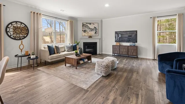 a living room with furniture a large window and a fireplace