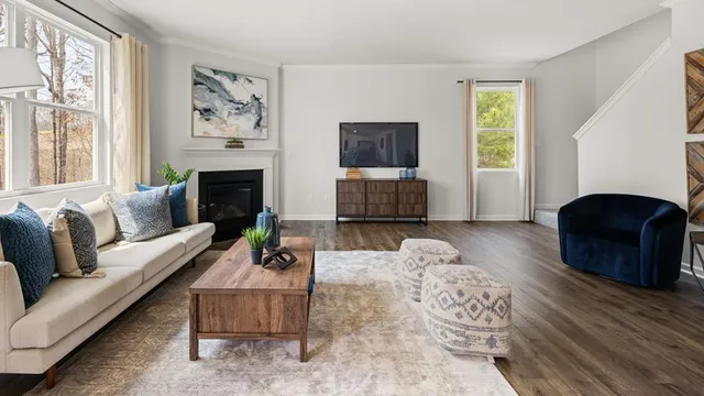 a living room with furniture a flat screen tv and a fireplace