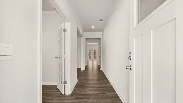 a view of a hallway with wooden floor
