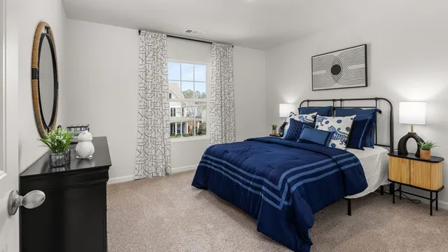 a bedroom with a bed and a potted plant