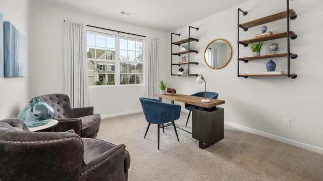 a living room with furniture a window and a chair