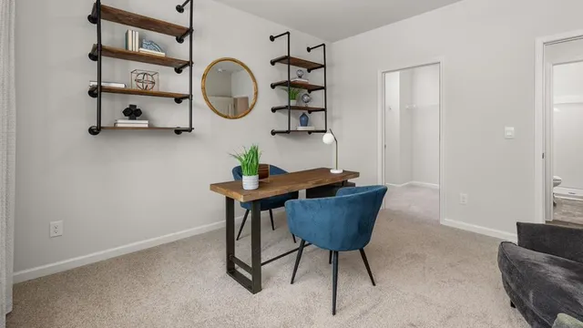 a view of a room with furniture and mirror