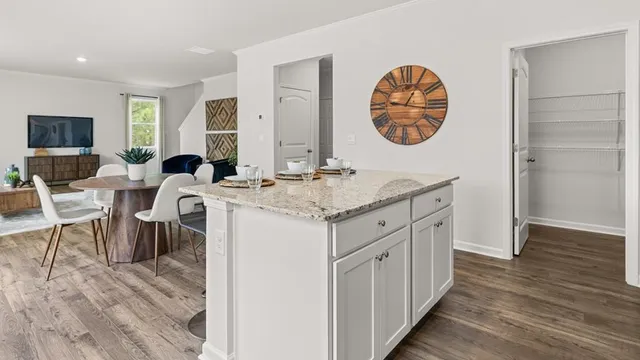 a kitchen with a sink cabinets and a wooden floor