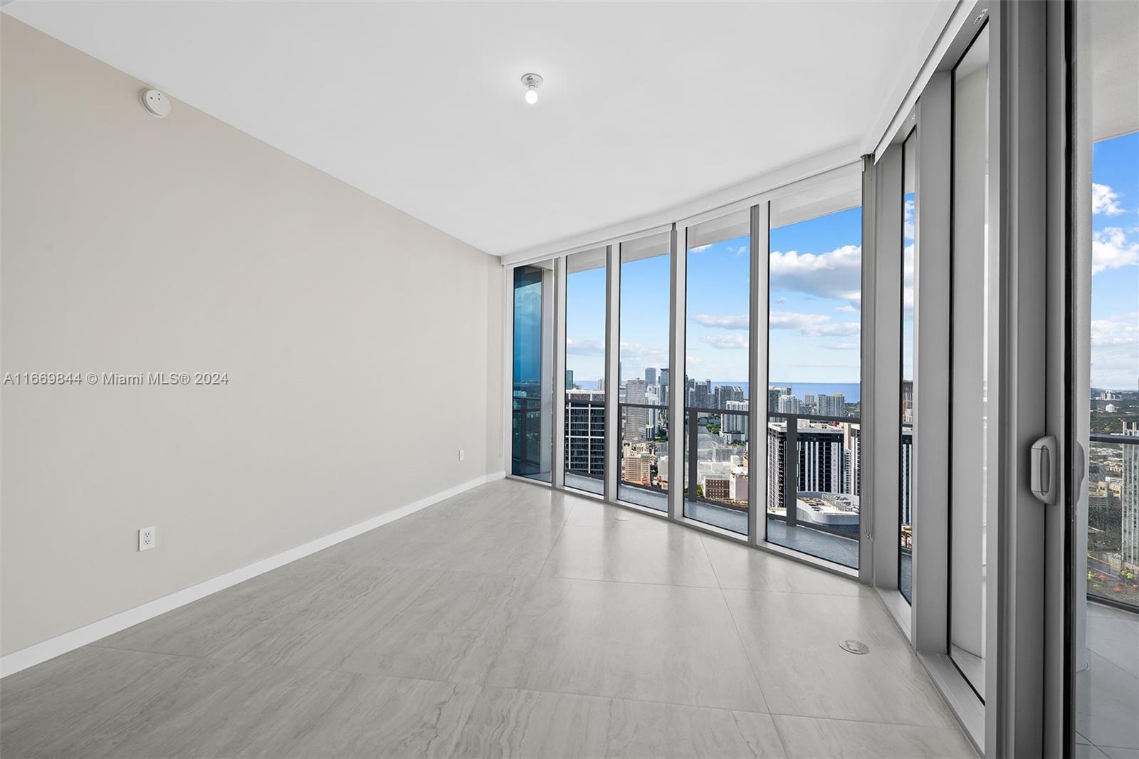 851 Northeast 1st Avenue, Unit PH5412 Miami, FL 33132 - Photo 15 of 65 a view of an empty room with glass door