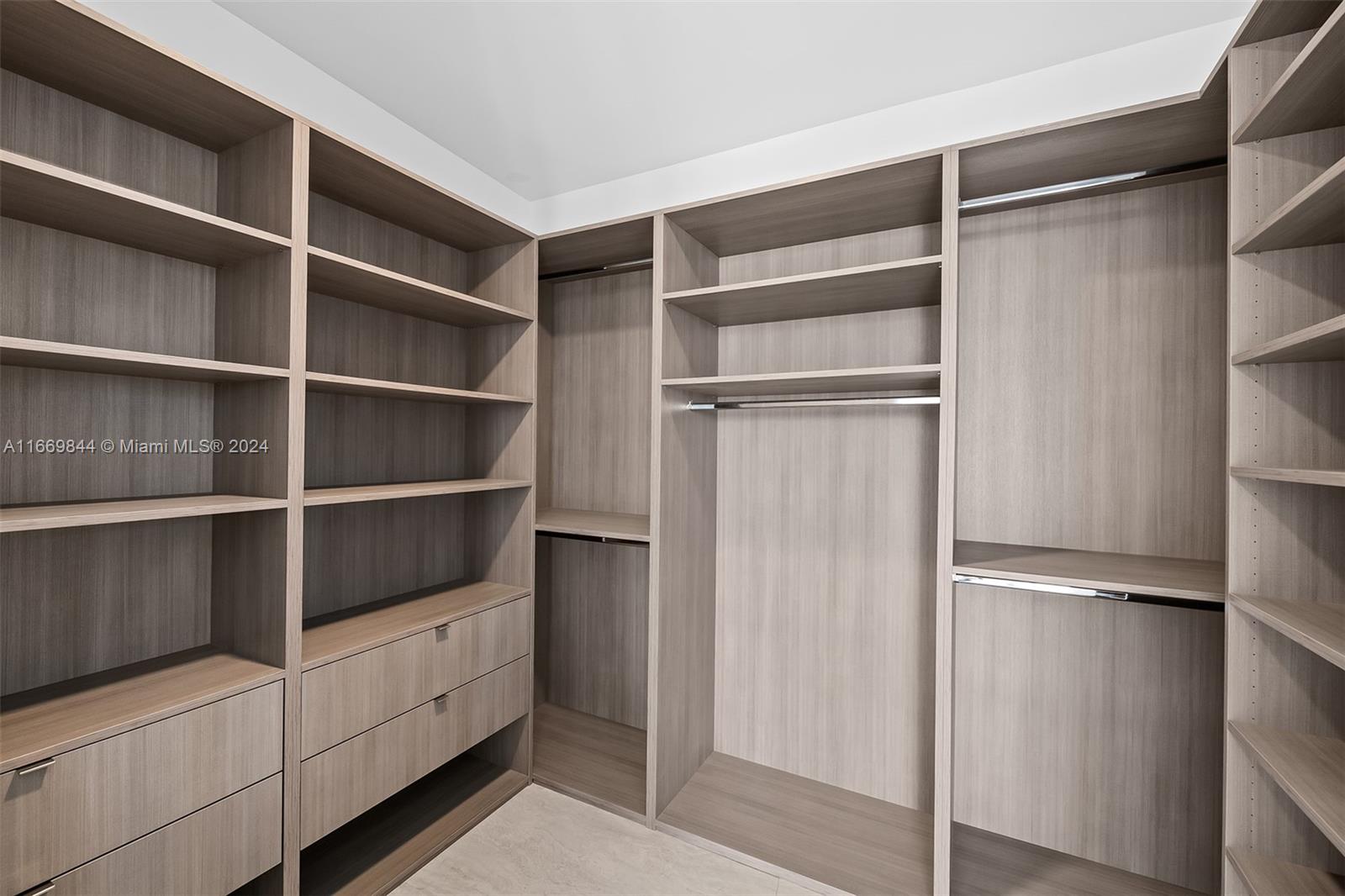 851 Northeast 1st Avenue, Unit PH5412 Miami, FL 33132 - Photo 18 of 65 a view of walk in closet with empty racks