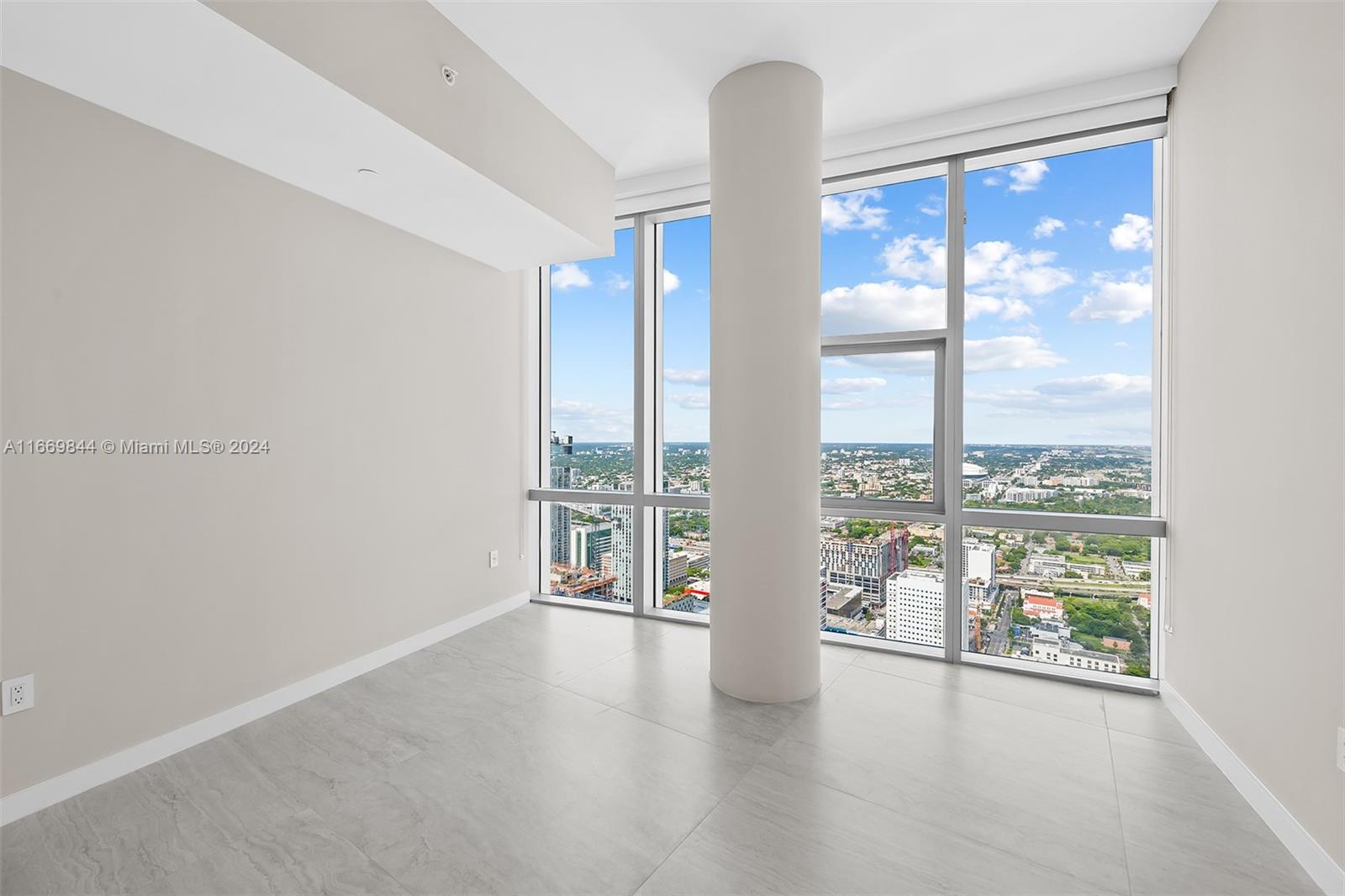 851 Northeast 1st Avenue, Unit PH5412 Miami, FL 33132 - Photo 31 of 65 wooden floor in an empty room with a window