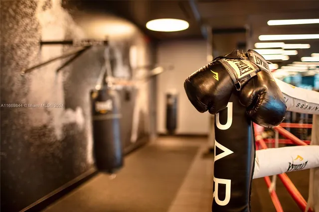 a table & chairs sitting in a bedroom next to a window
