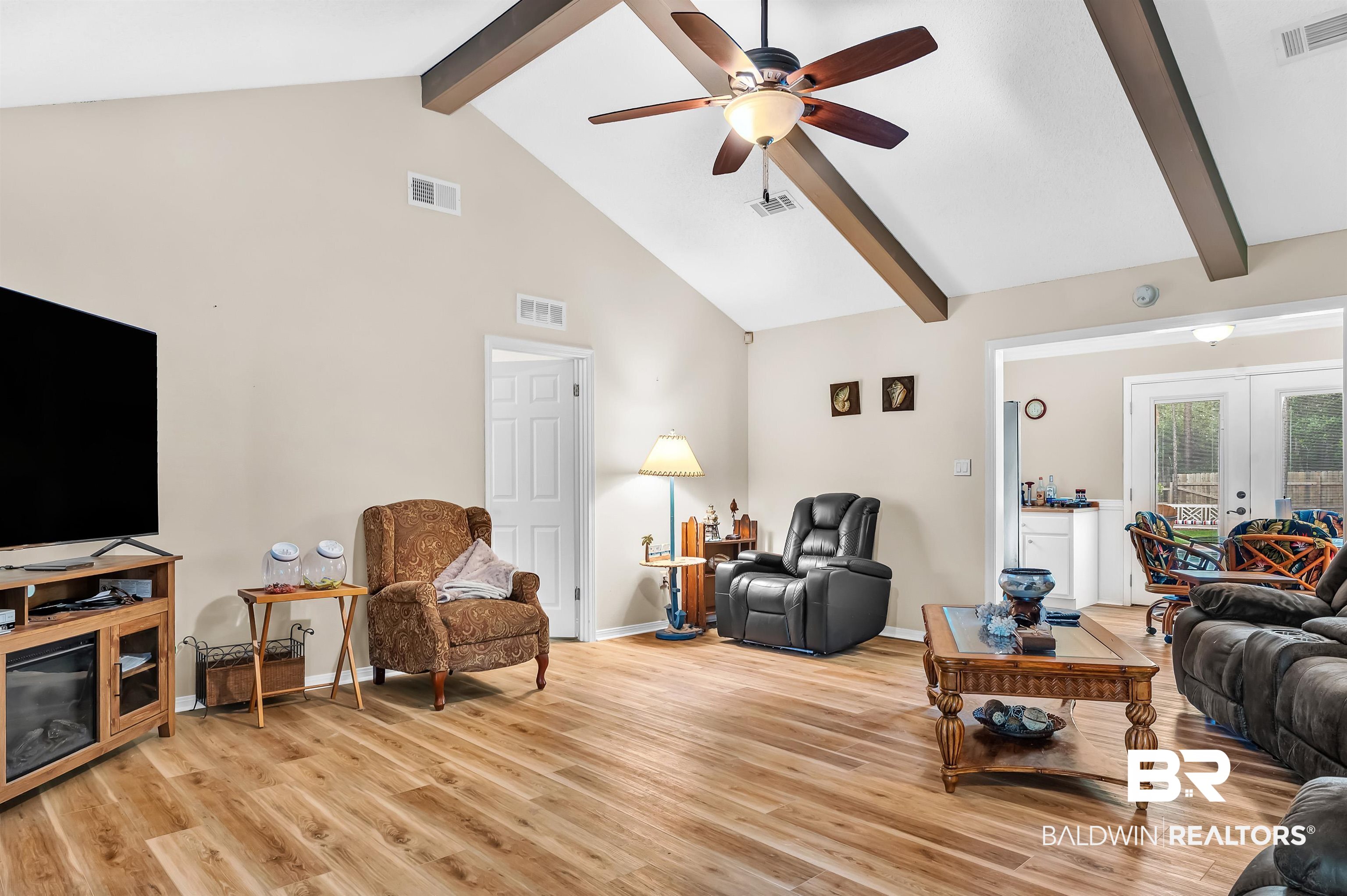 24551 Wolf Bay Drive Foley, AL 36535 - Photo 23 of 59 Living area featuring beam ceiling, high vaulted ceiling, a ceiling fan, light wood-style flooring, and french doors