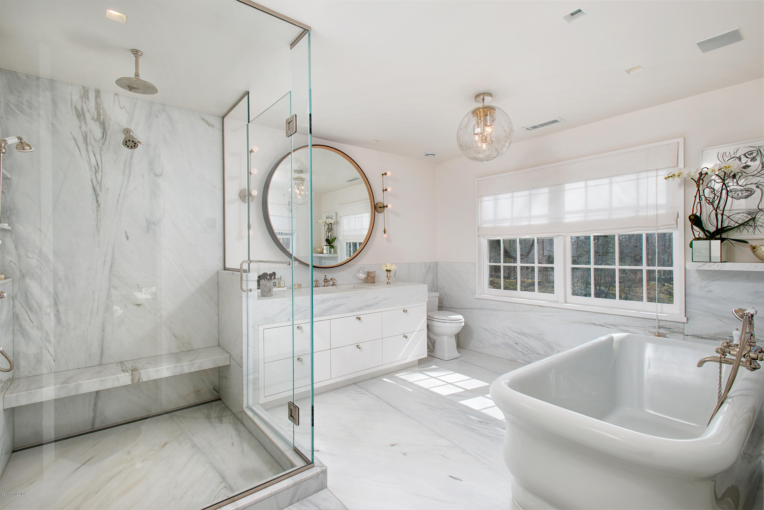 46 Quail Road Greenwich, CT 06831 - Photo 11 of 22 a bathroom with a tub a sink and a large mirror