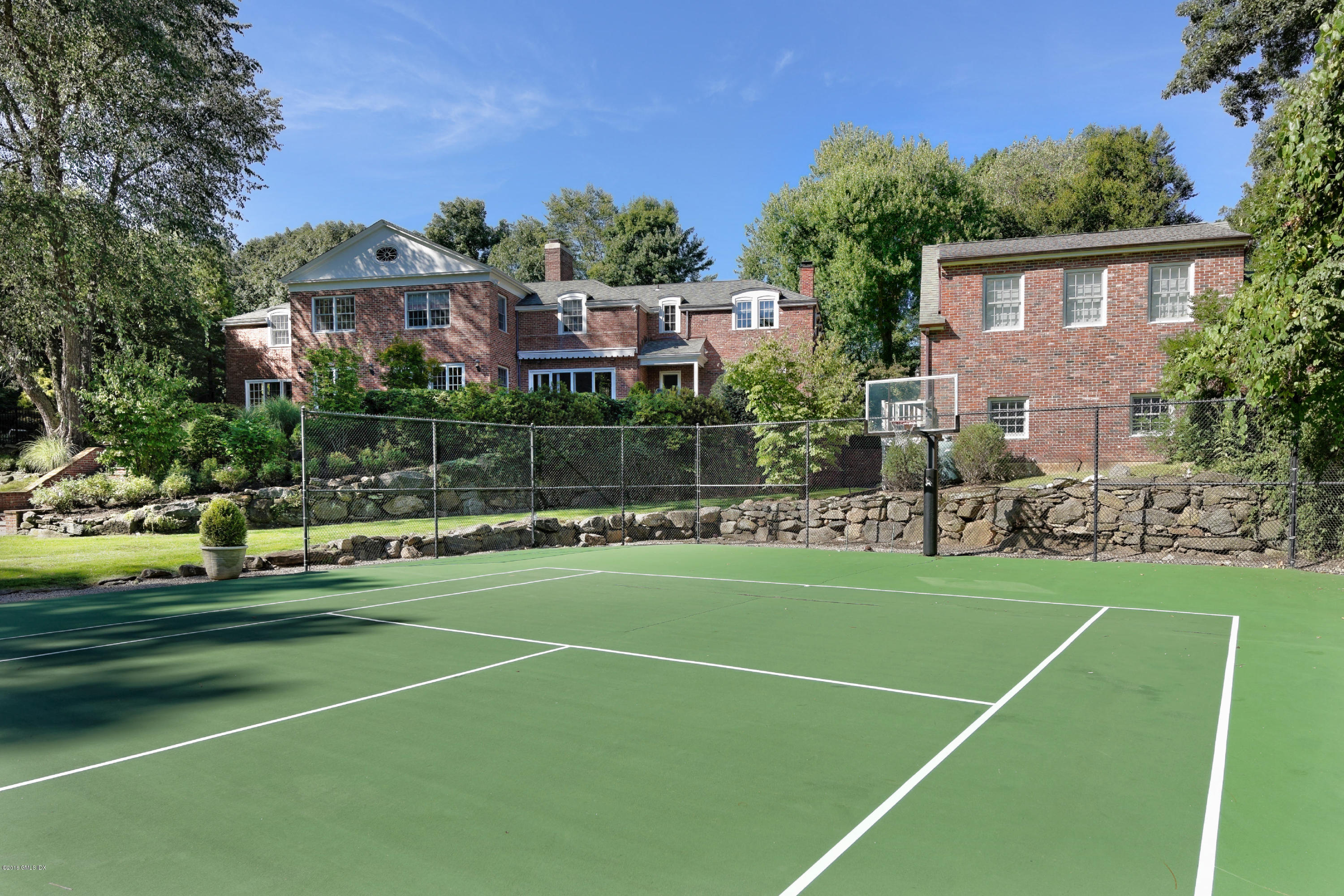 46 Quail Road Greenwich, CT 06831 - Photo 16 of 22 a view of a tennis ground with large trees