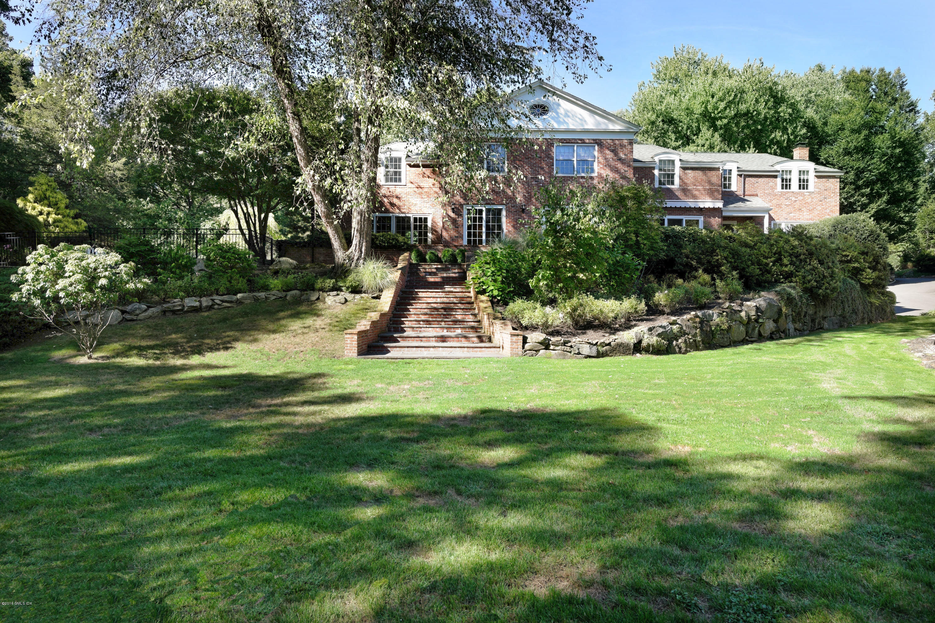46 Quail Road Greenwich, CT 06831 - Photo 17 of 22 a view of a house with a yard and sitting area