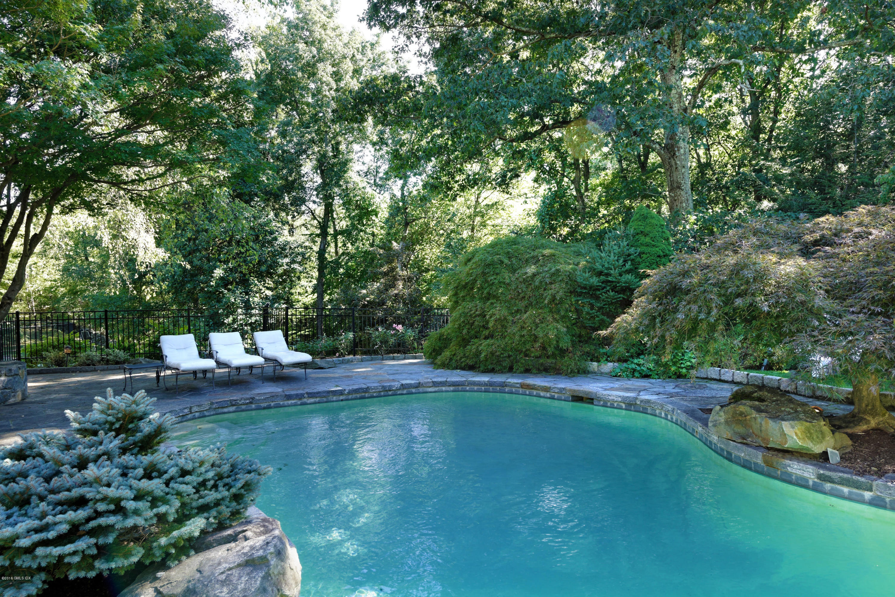 46 Quail Road Greenwich, CT 06831 - Photo 19 of 22 a view of a lake with trees all around