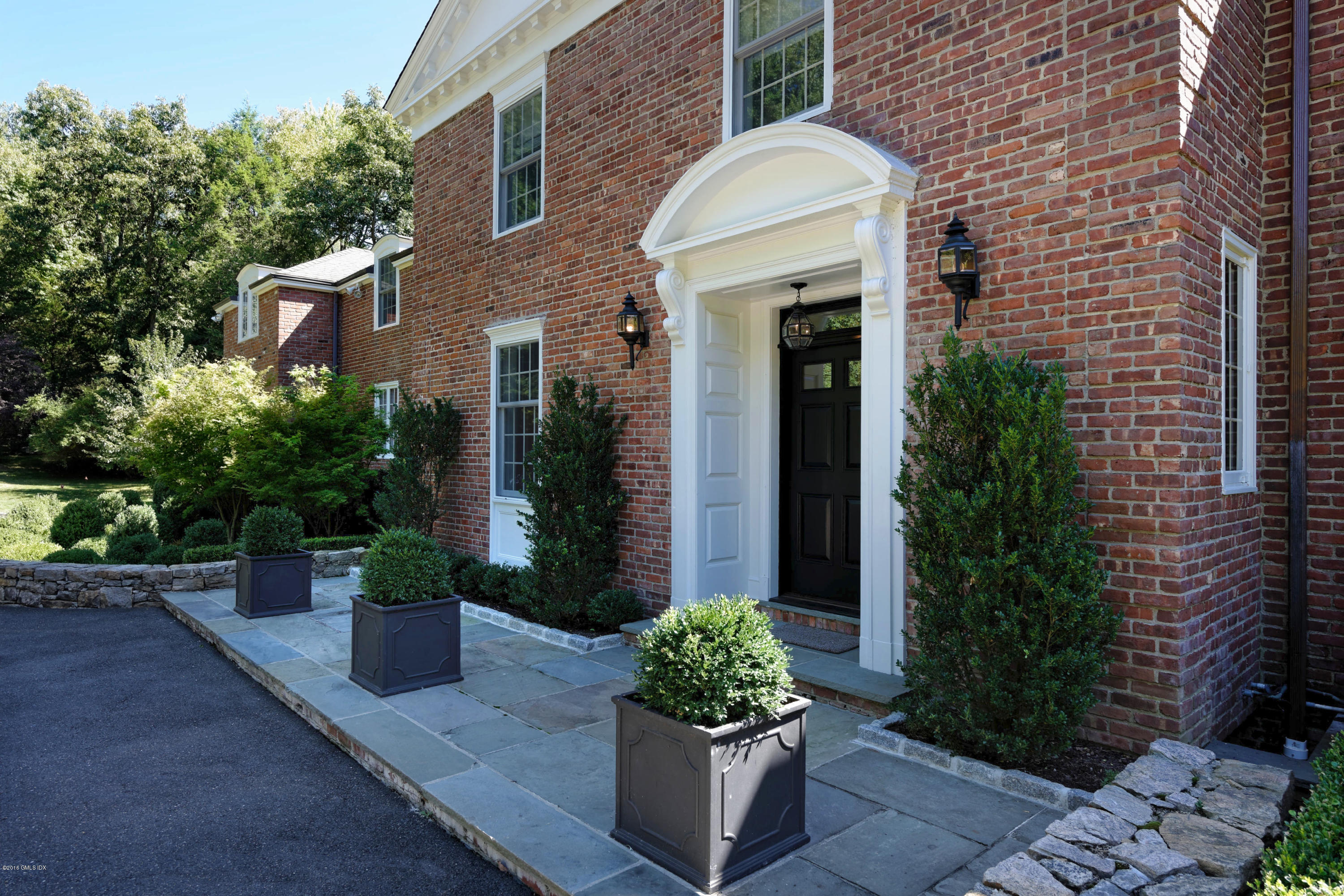 46 Quail Road Greenwich, CT 06831 - Photo 2 of 22 a front view of a house with plants