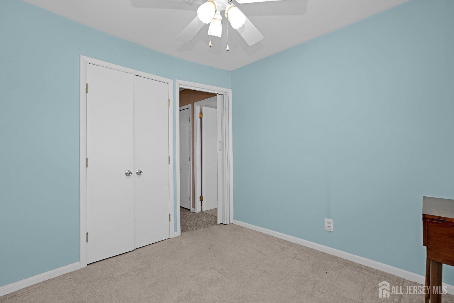 52 Markham Road Edison, NJ 08817 - Photo 17 of 28 an empty room with a chandelier fan
