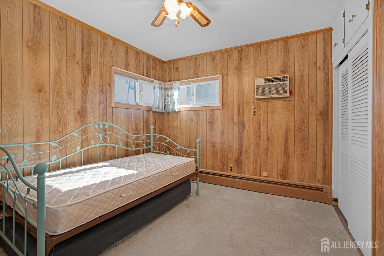52 Markham Road Edison, NJ 08817 - Photo 18 of 28 a bedroom with a bed and a chandelier
