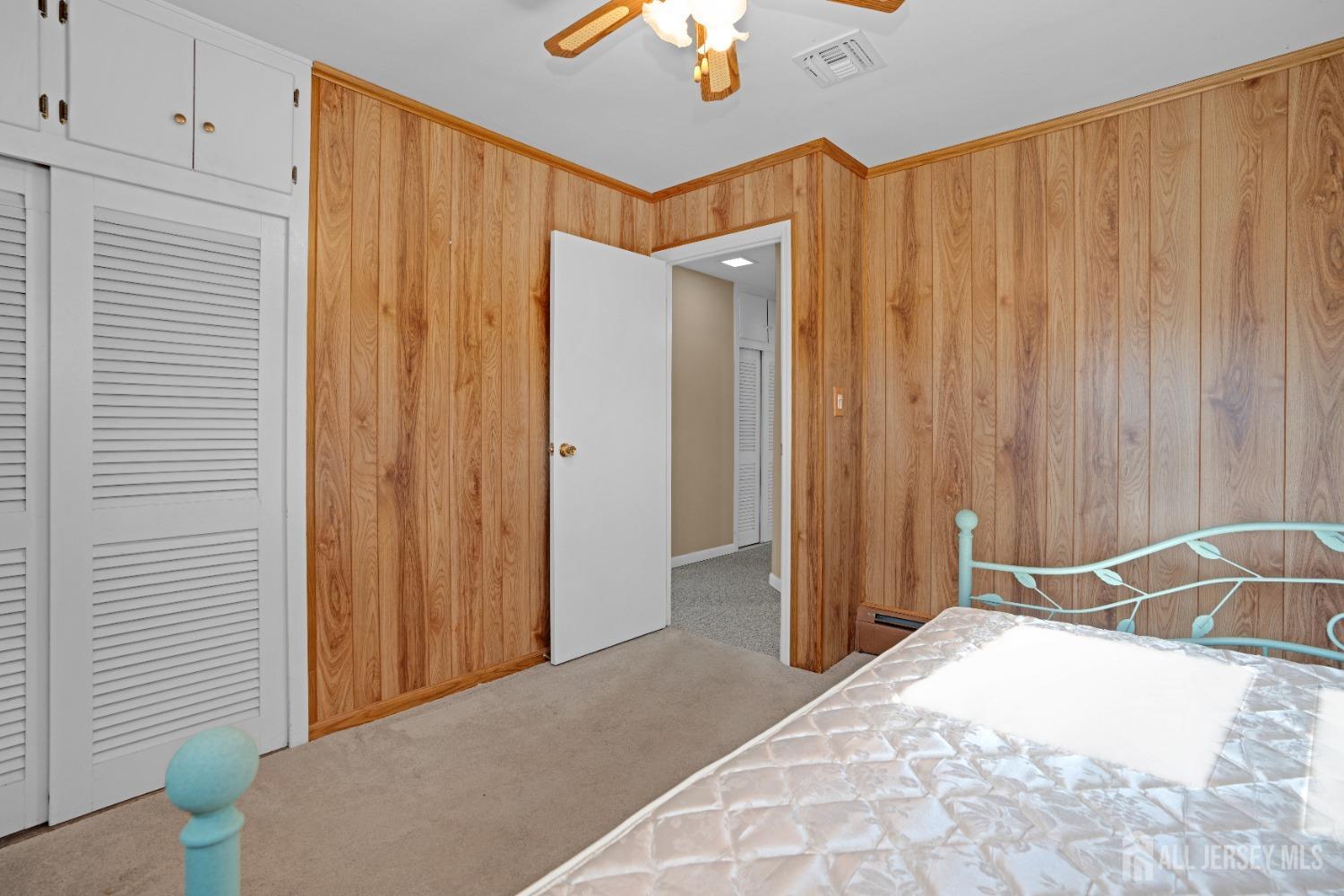 52 Markham Road Edison, NJ 08817 - Photo 19 of 28 a bedroom with a bed and a chandelier