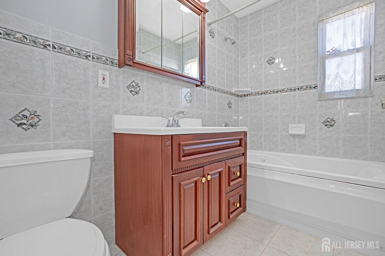 52 Markham Road Edison, NJ 08817 - Photo 20 of 28 a bathroom with a sink a toilet and a bathtub