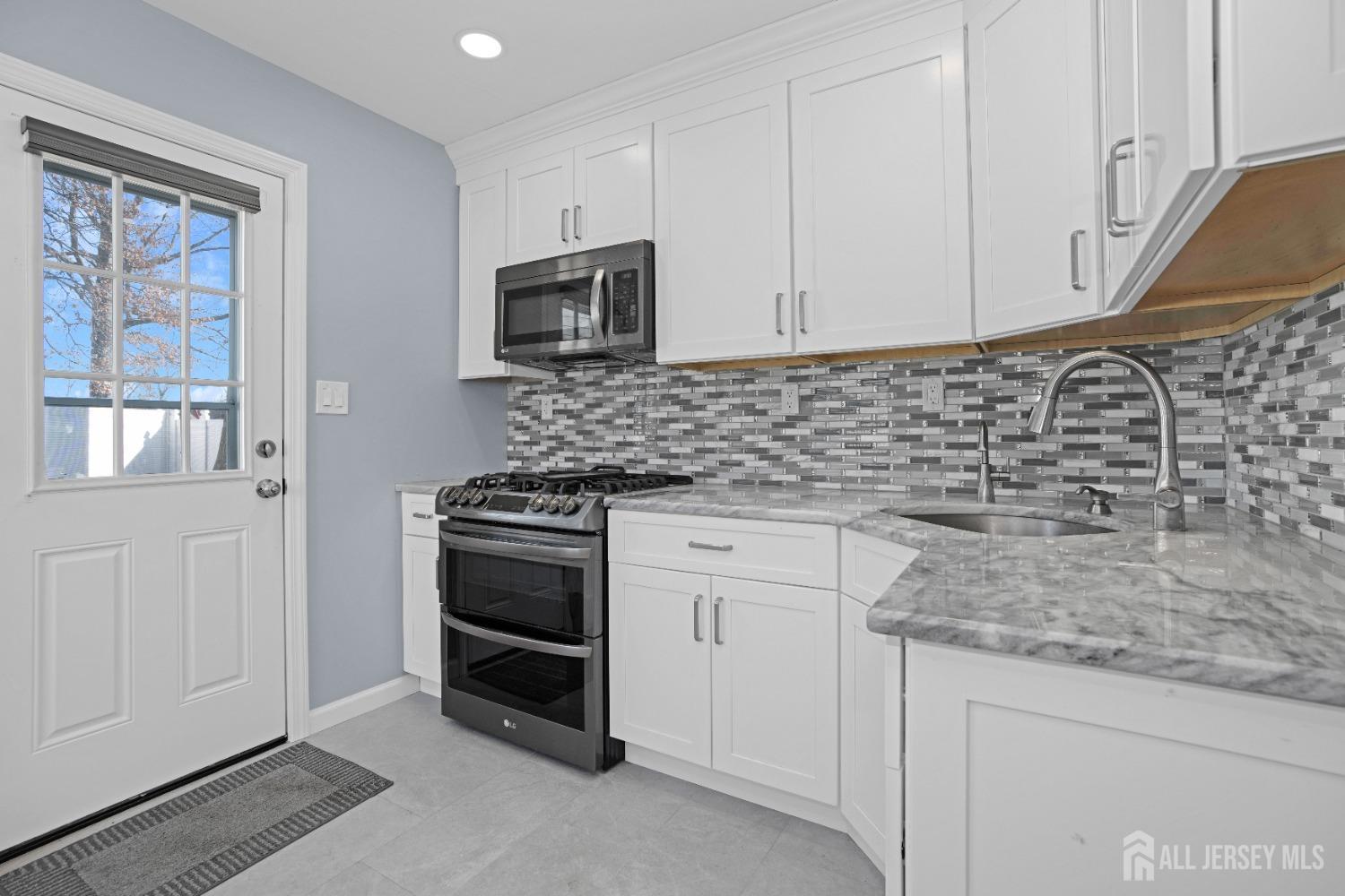 52 Markham Road Edison, NJ 08817 - Photo 10 of 28 a kitchen with stainless steel appliances granite countertop white cabinets and a stove