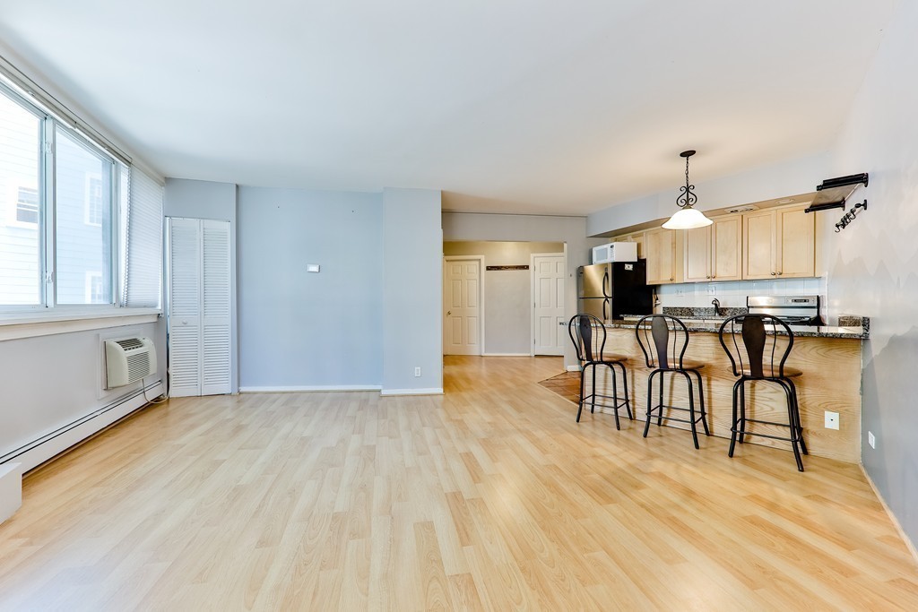 a view of kitchen with furniture and wooden floor