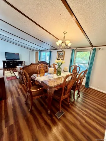 a dining room with furniture and wooden floor