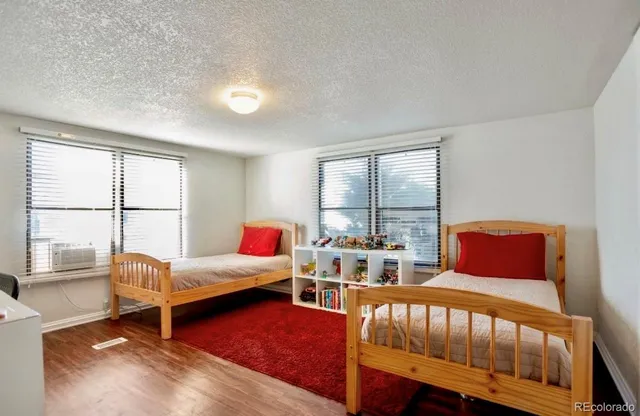 a bedroom with two beds and a large window