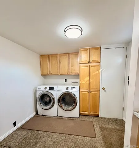 a utility room with sink dryer and washer