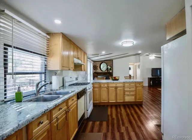 a large kitchen with a large window and stainless steel appliances