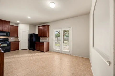 a kitchen with stainless steel appliances a refrigerator and a stove top oven