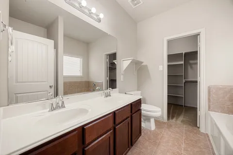 a white bath tub sitting in a bathroom next to a window