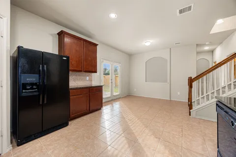 a kitchen with stainless steel appliances granite countertop a refrigerator and a sink