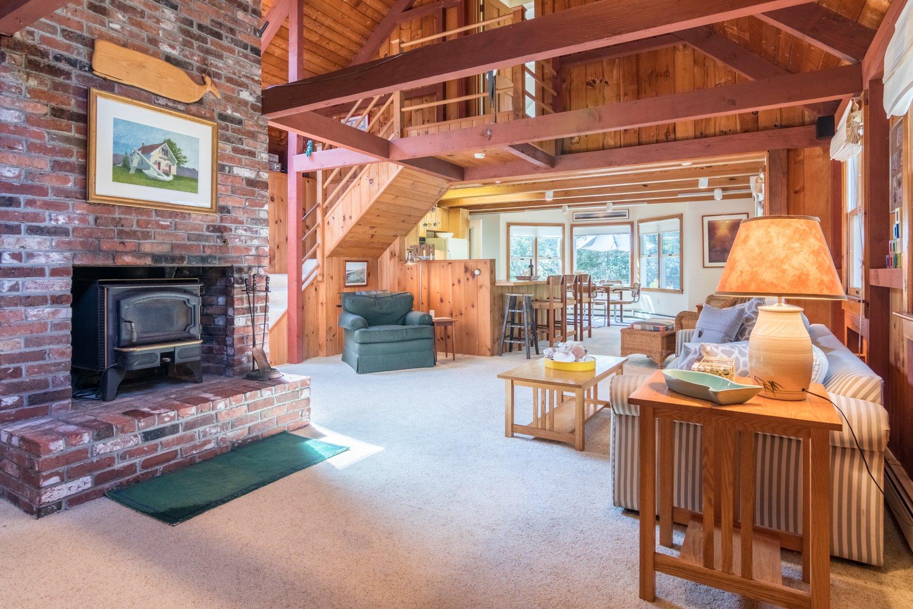 115 Cole Road Eastham, MA 02642 - Photo 11 of 33 a living room with furniture and a fireplace