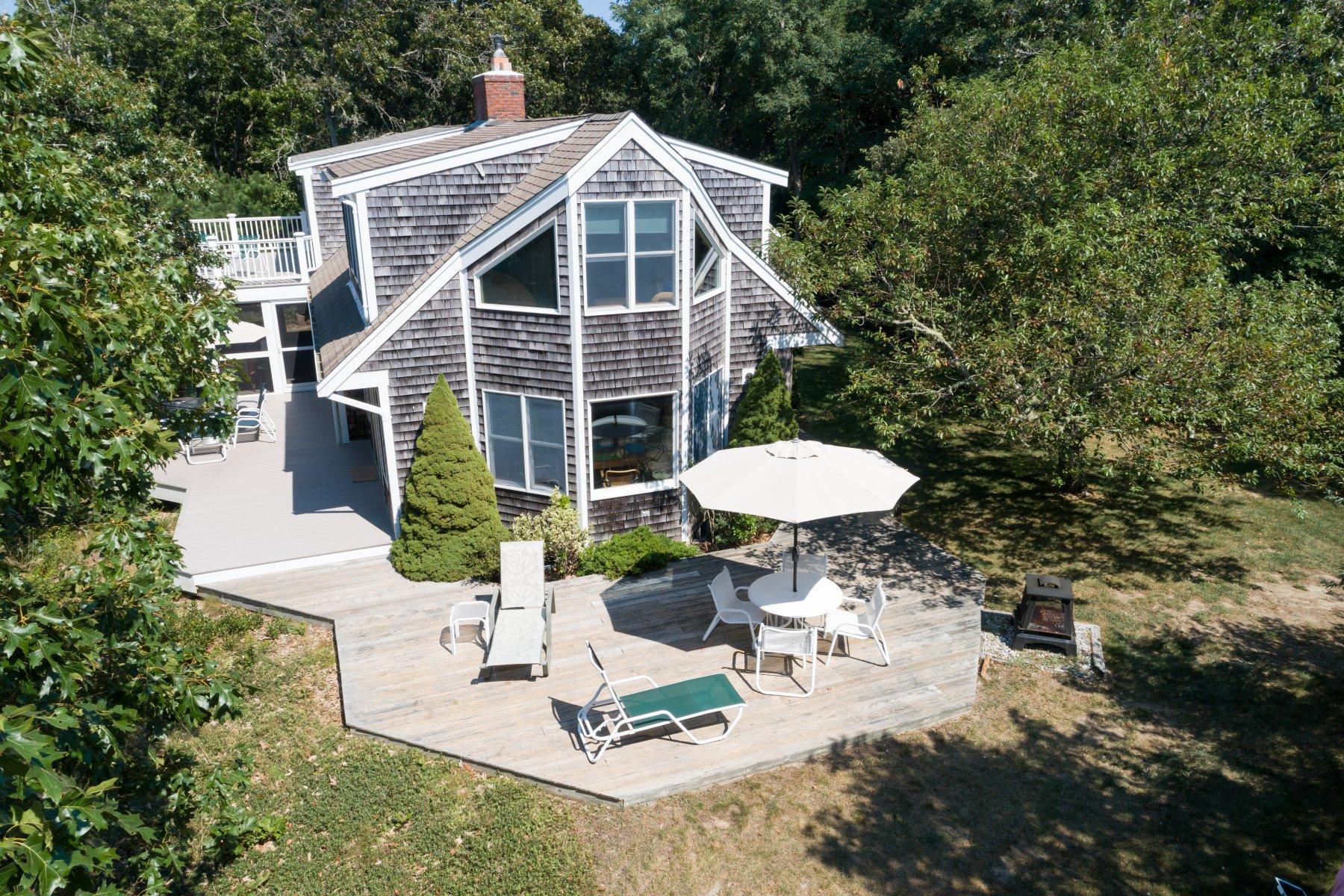 115 Cole Road Eastham, MA 02642 - Photo 3 of 33 a view of a table and chairs under an umbrella