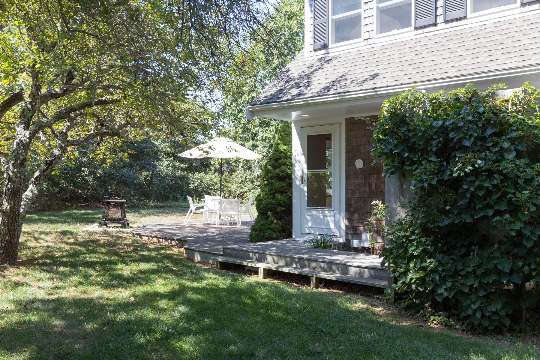 115 Cole Road Eastham, MA 02642 - Photo 31 of 33 a view of a house with backyard and sitting area