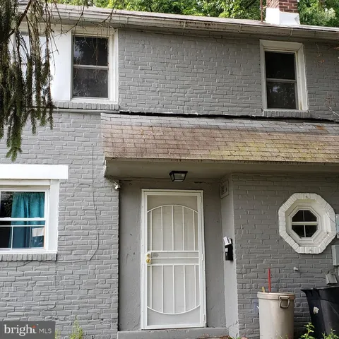 a front view of a house with plants
