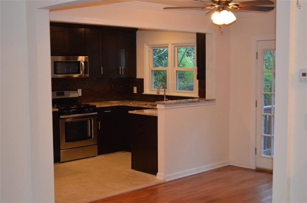 1329 Westridge Road Southwest Atlanta, GA 30311 - Photo 25 of 54 a kitchen with a stove and a microwave