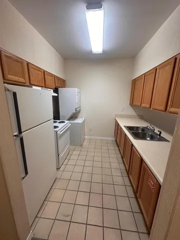 a kitchen with stainless steel appliances a refrigerator sink and stove