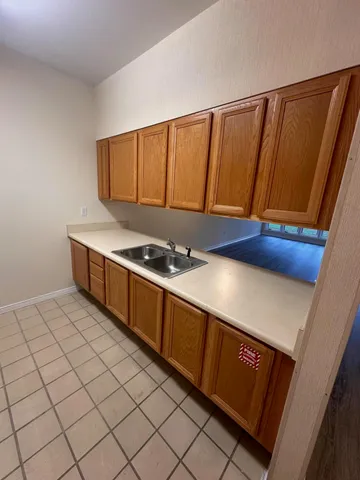 a kitchen with stainless steel appliances a sink stove and cabinets