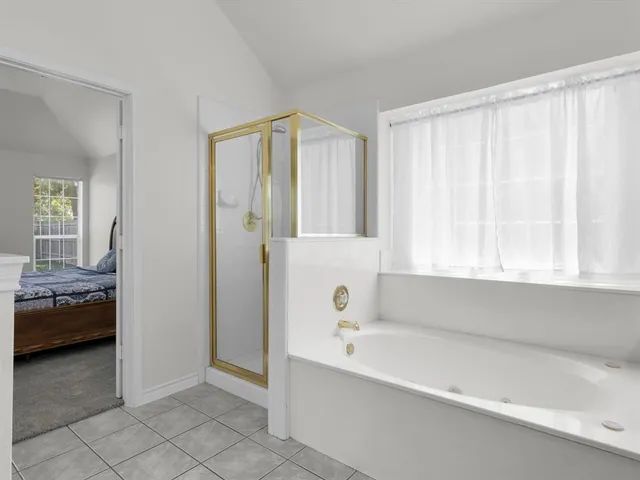 a bathroom with a tub and a view of bathroom