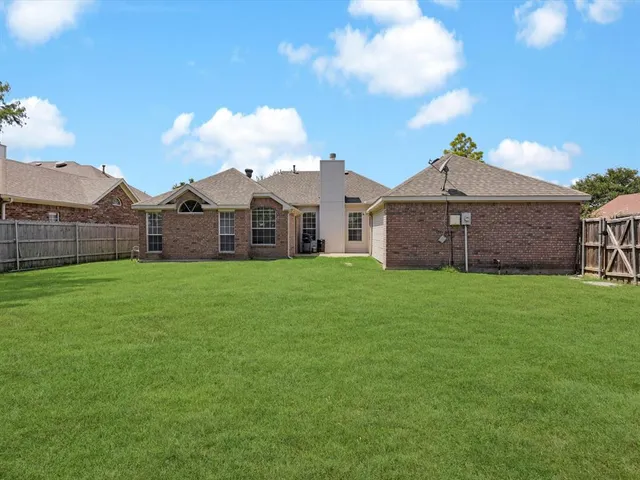 a front view of a house with a garden and yard