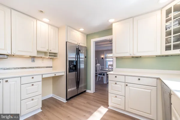 a kitchen with white cabinets and white stainless steel appliances