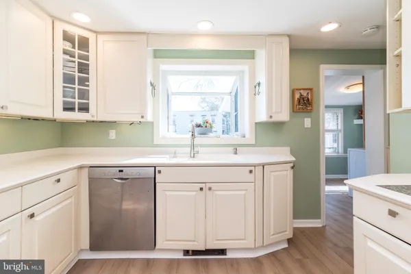 a kitchen with a sink cabinets appliances and a window