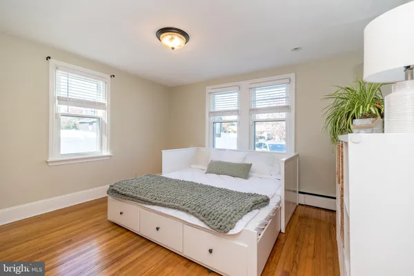 a living room with a bed furniture and a window