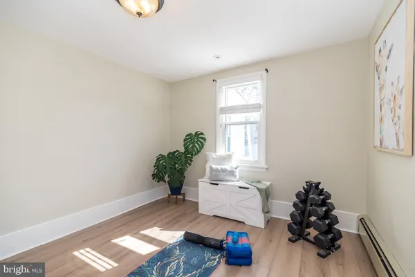 a room with wooden floor and a window