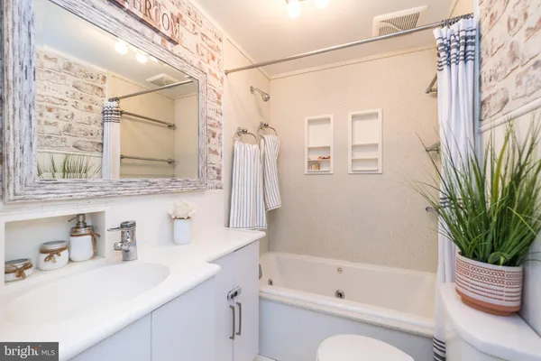a bathroom with a sink a toilet and a bathtub