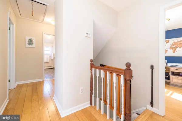 a workspace room with furniture and a potted plant